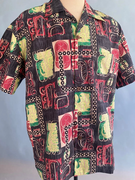 Vintage-inspired Hawaiian shirt with bold red, green, and black abstract print on mannequin
